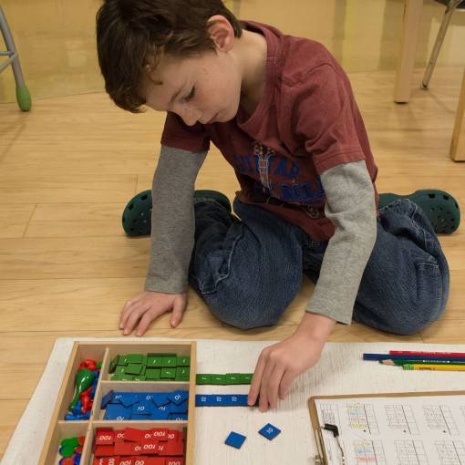 Elementary student with math tiles